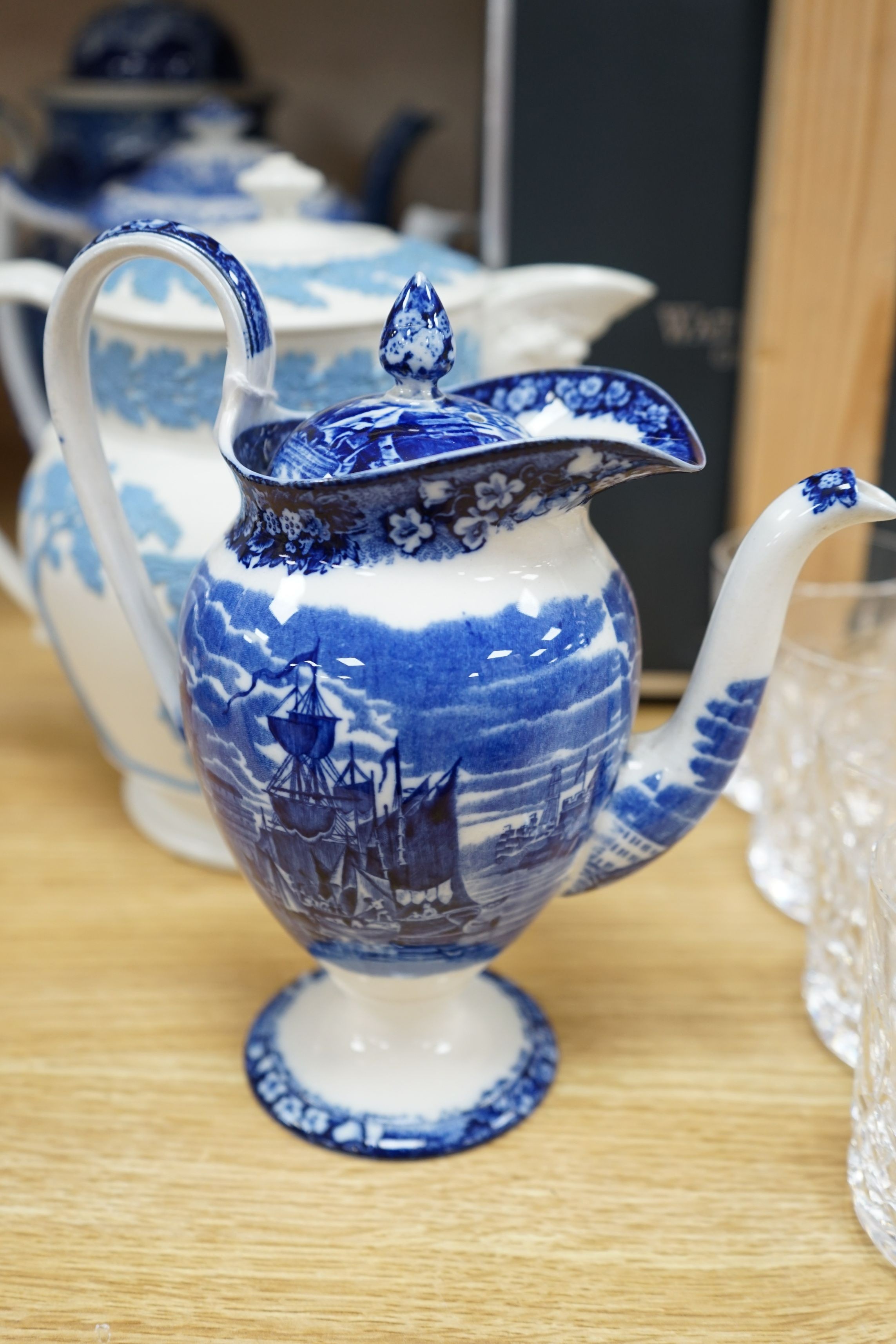 An early 19th century pearlware blue and white tea pot, two others and a Wedgwood style teapot, tallest 30cms high